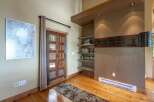 Step into this inviting entryway featuring a rustic wooden door with glass panels, perfect for letting in natural light.