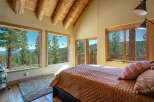 Experience breathtaking mountain views from this stunning bedroom, featuring expansive windows that bring the outdoors in.