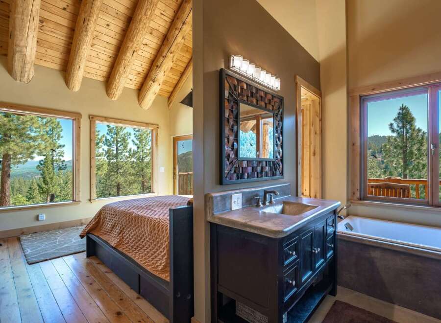 Experience breathtaking mountain views from this stunning bedroom and bathroom suite.
