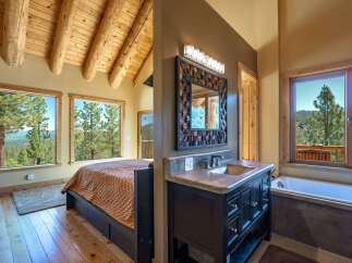 Experience breathtaking mountain views from this stunning bedroom and bathroom suite.