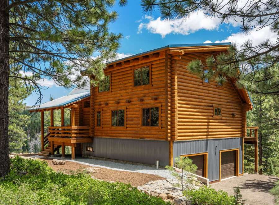 Experience rustic charm in this stunning log cabin nestled amidst a picturesque forest setting.