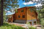 Experience rustic charm in this stunning log cabin nestled amidst a picturesque forest setting.