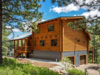Experience rustic charm in this stunning log cabin nestled amidst a picturesque forest setting.