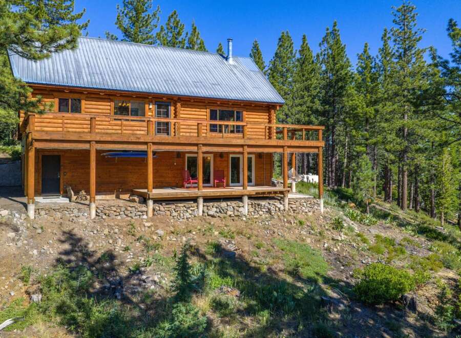 Experience rustic charm in this stunning log cabin nestled amidst towering pine trees.