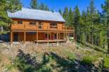Experience rustic charm in this stunning log cabin nestled amidst towering pine trees.
