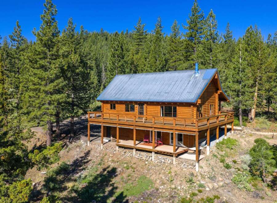 Experience rustic charm in this stunning log cabin nestled amidst a serene pine forest.