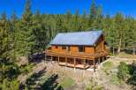 Experience rustic charm in this stunning log cabin nestled amidst a serene pine forest.