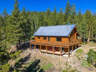 Experience rustic charm in this stunning log cabin nestled amidst a serene pine forest.