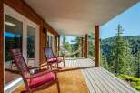 Enjoy breathtaking mountain views from this charming covered porch, complete with comfortable rocking chairs and a relaxing hammock.