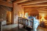Experience rustic charm in this cozy log cabin bedroom, featuring a handcrafted log bed and warm wood accents throughout.