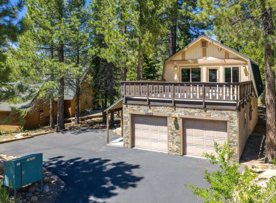 Discover this charming mountain home featuring a spacious deck perfect for enjoying the surrounding pine forest.