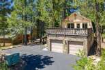 Discover this charming mountain home featuring a spacious deck perfect for enjoying the surrounding pine forest.