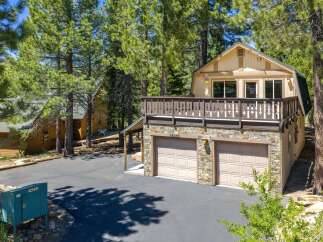 Discover this charming mountain home featuring a spacious deck perfect for enjoying the surrounding pine forest.