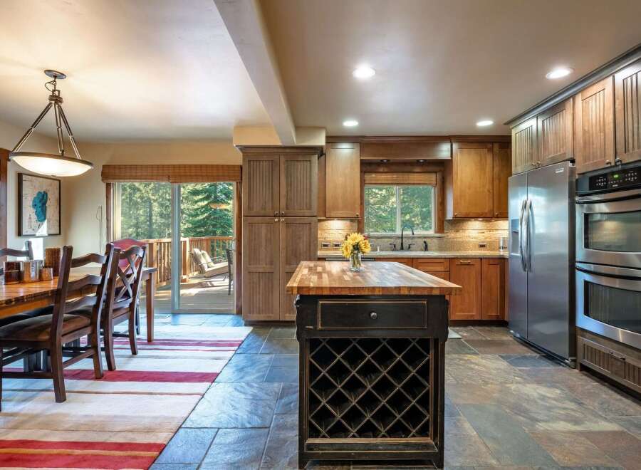 This spacious kitchen and dining area offers a warm and inviting atmosphere, perfect for entertaining.