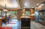 This spacious kitchen and dining area offers a warm and inviting atmosphere, perfect for entertaining.