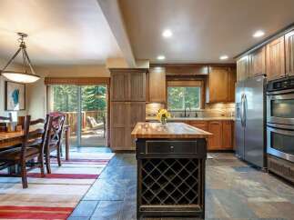 This spacious kitchen and dining area offers a warm and inviting atmosphere, perfect for entertaining.
