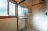 Step into this beautifully appointed bathroom featuring a spacious glass-enclosed shower with elegant tilework.