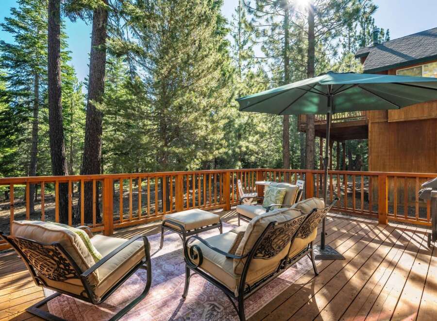 Enjoy the serene mountain lifestyle on this spacious wooden deck, perfect for outdoor entertaining.
