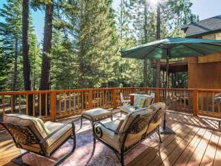Enjoy the serene mountain lifestyle on this spacious wooden deck, perfect for outdoor entertaining.