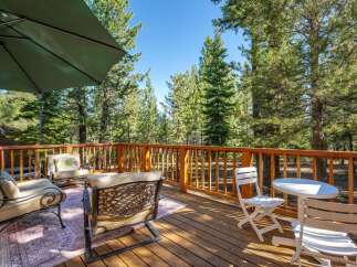 Enjoy the serene mountain views from this spacious wooden deck, perfect for outdoor entertaining or quiet relaxation.