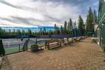Enjoy a game of tennis on these pristine courts, surrounded by the serene beauty of tall pine trees.