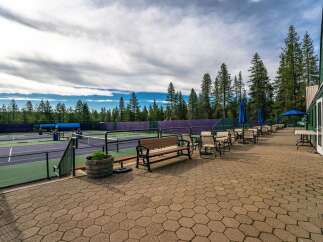 Enjoy a game of tennis on these pristine courts, surrounded by the serene beauty of tall pine trees.