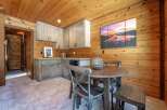 Experience cozy living in this charming cabin-style room, featuring warm wood-paneled walls and ceiling.