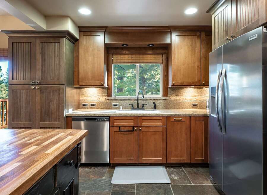 This spacious kitchen boasts beautiful wooden cabinetry and granite countertops, perfect for any home chef.