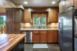 This spacious kitchen boasts beautiful wooden cabinetry and granite countertops, perfect for any home chef.