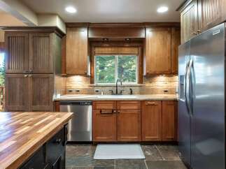 This spacious kitchen boasts beautiful wooden cabinetry and granite countertops, perfect for any home chef.