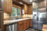 This kitchen boasts beautiful wooden cabinetry and granite countertops, creating a warm and inviting atmosphere.
