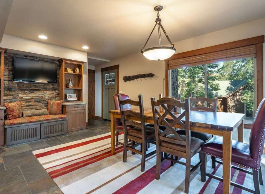 Experience rustic charm in this inviting dining area, featuring a sturdy wooden table and chairs perfect for family meals.