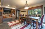 Experience rustic charm in this inviting dining area, featuring a sturdy wooden table and chairs perfect for family meals.