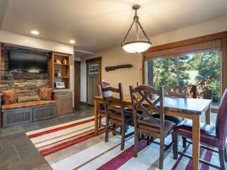 Experience rustic charm in this inviting dining area, featuring a sturdy wooden table and chairs perfect for family meals.
