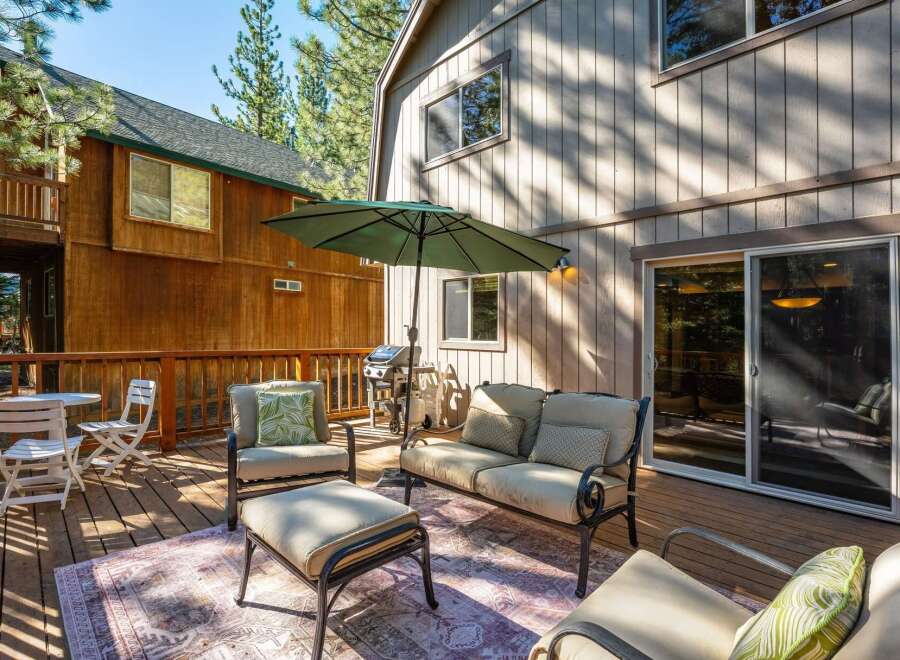 Enjoy outdoor living on this spacious wooden deck, perfect for entertaining or relaxing.