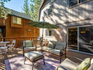 Enjoy outdoor living on this spacious wooden deck, perfect for entertaining or relaxing.
