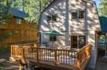 Enjoy outdoor living on this spacious wooden deck, perfect for entertaining or relaxing.