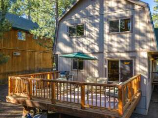 Enjoy outdoor living on this spacious wooden deck, perfect for entertaining or relaxing.