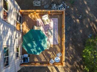 Enjoy outdoor living on this spacious wooden deck, perfect for entertaining or relaxing.