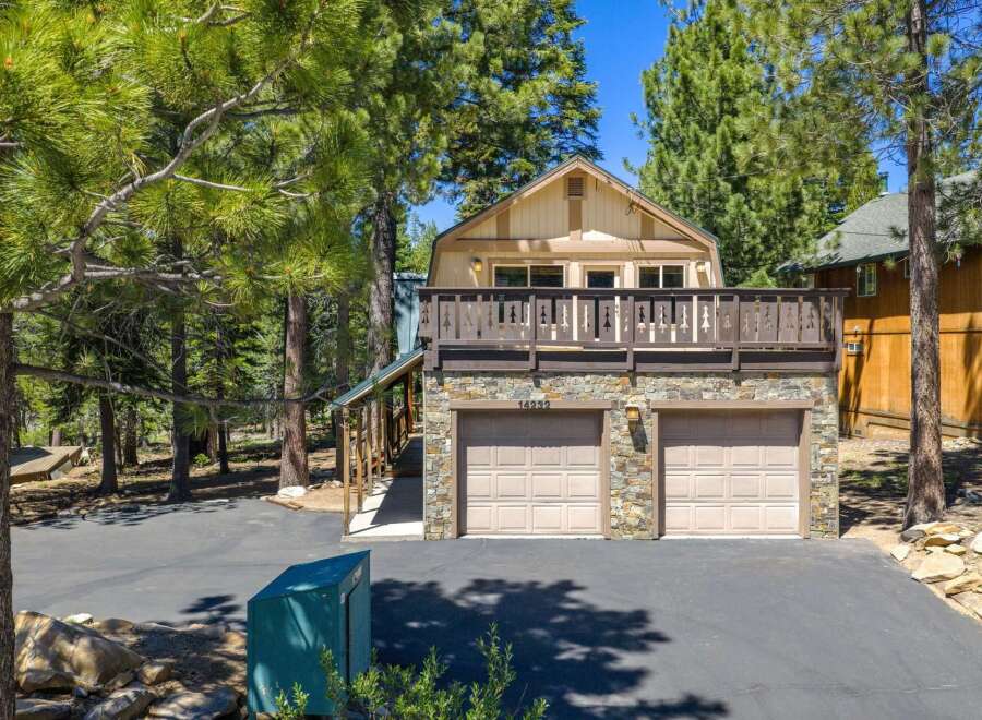 Discover this charming mountain home featuring a spacious upper-level deck perfect for enjoying the surrounding pine forest views.