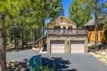 Discover this charming mountain home featuring a spacious upper-level deck perfect for enjoying the surrounding pine forest views.