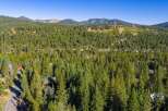 Nestled amidst a dense forest of evergreen trees, this property offers a secluded mountain retreat.