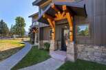 Experience modern mountain living with this stunning property featuring a stone and wood exterior.