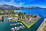 Experience luxury living with this stunning aerial view of a waterfront property featuring a private marina and modern townhomes.