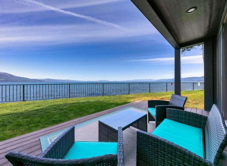 Enjoy breathtaking lake views from this stunning property's covered patio, perfect for relaxing or entertaining.