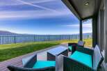 Enjoy breathtaking lake views from this stunning property's covered patio, perfect for relaxing or entertaining.