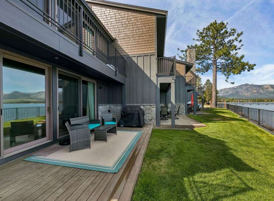 Enjoy breathtaking lake and mountain views from this stunning property's private deck, perfect for outdoor entertaining.