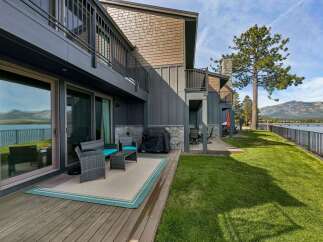 Enjoy breathtaking lake and mountain views from this stunning property's private deck, perfect for outdoor entertaining.
