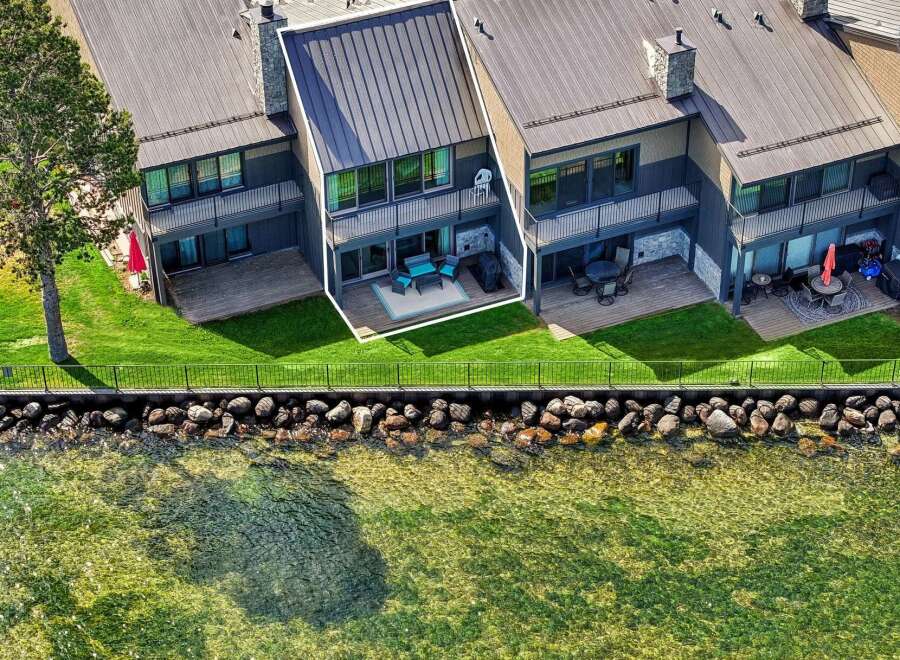 Experience luxurious waterfront living in this stunning townhome, featuring a private deck with breathtaking lake views.