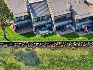 Experience luxurious waterfront living in this stunning townhome, featuring a private deck with breathtaking lake views.
